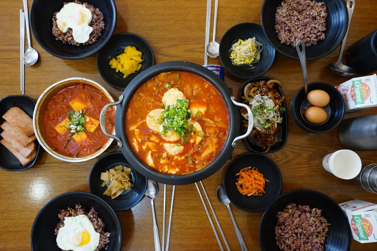 위에서 본 한 상 — 가운데 찌개 냄비와 잡곡밥, 계란프라이, 여러 반찬